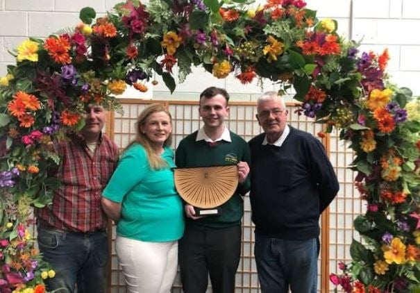 Ciaran Rowsome receiving his award with Richar Millar (on RHS) and his parents.